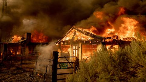 Fire consumes homes as the Sugar Fire, part of the Beckwourth Complex Fire, tears through Doyle, California, on Saturday, July 10.