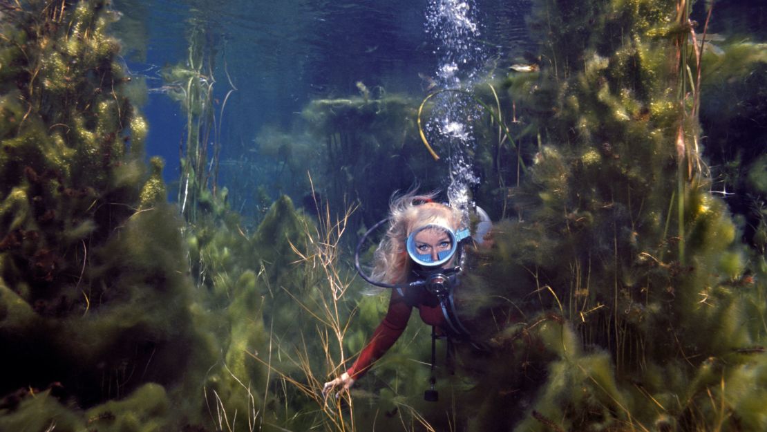 Shark advocate Valerie Taylor, filmed underwater in 1975, taught herself how to scuba dive six decades ago.