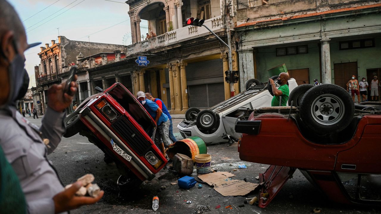 Cars are overturned in the street as people in Havana, Cuba, take part in protests on Sunday, July 11. Thousands of Cubans <a href="https://www.cnn.com/2021/07/11/americas/cuba-protests/index.html" target="_blank">took to the streets Sunday</a> to protest a lack of food and medicine as the country undergoes a grave economic crisis aggravated by the Covid-19 pandemic and US sanctions. Many chanted for "freedom" and called for President Miguel Díaz-Canel to step down.