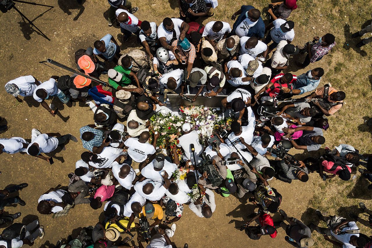 Members of the press gather around supporters of Jovenel Moise, the late President of Haiti, as they create a memorial outside the presidential palace in Port-au-Prince on Wednesday, July 14. <a href="https://www.cnn.com/2021/07/07/americas/haiti-president-jovenel-moise-attack-intl/index.html" target="_blank">Moise was assassinated a week earlier</a> during an attack on his private residence.