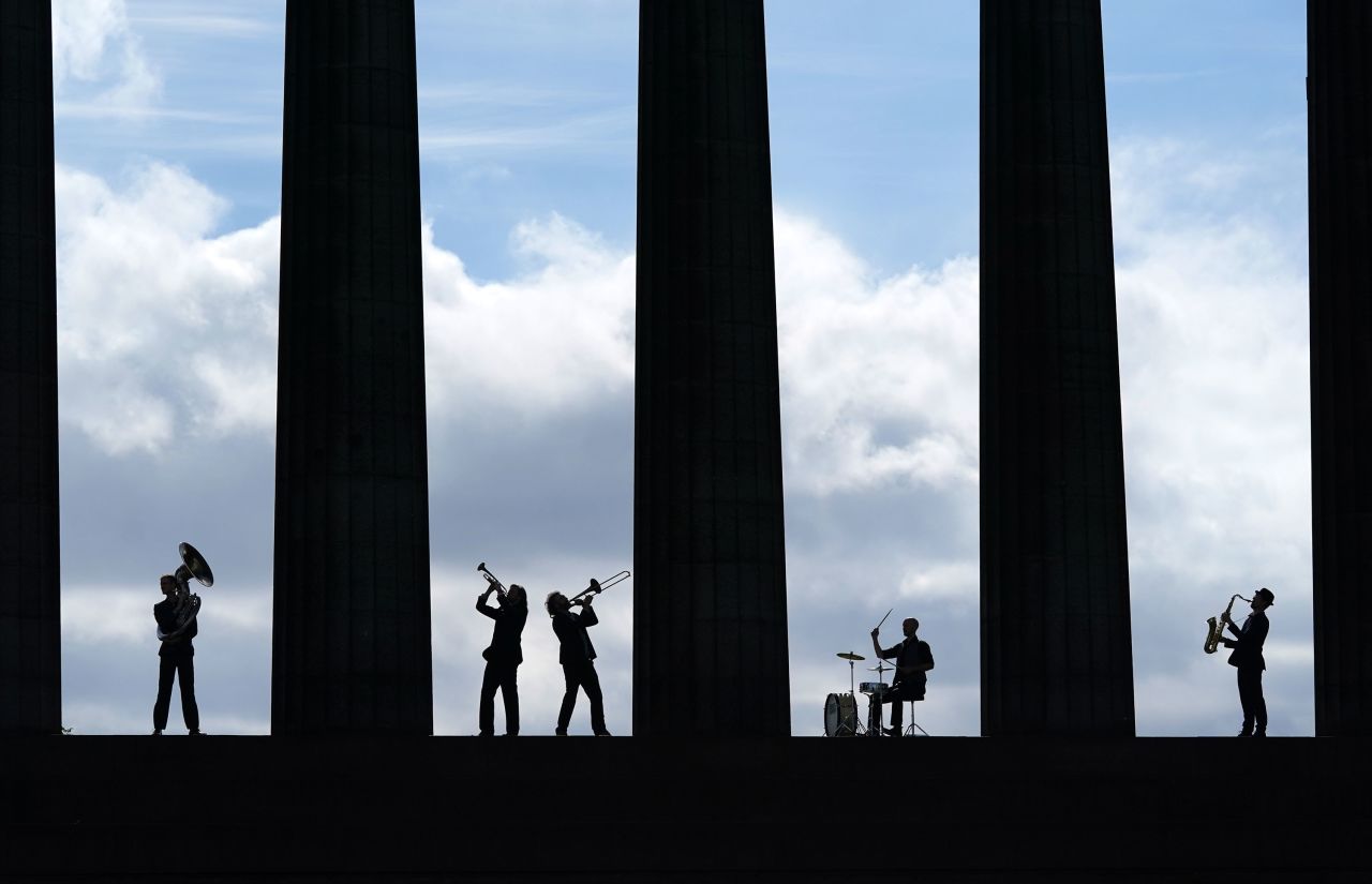Members of the band Brass Gumbo play instruments at the National Monument of Scotland during a photo call for the Edinburgh Jazz and Blues Festival on Thursday, July 8.