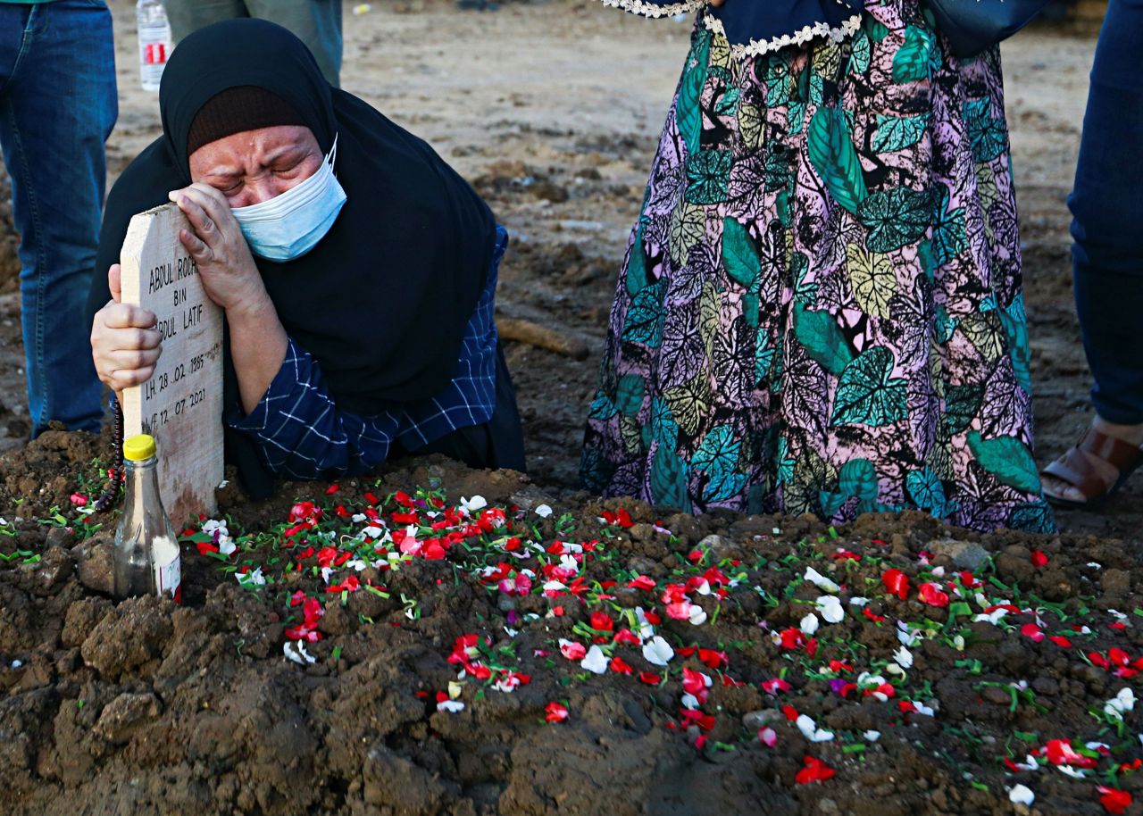 A relative of Abdul Rochman, a 36-year-old man who died from Covid-19, cries after his funeral in Jakarta, Indonesia, on Monday, July 12. The country is <a href="https://www.cnn.com/2021/07/05/asia/indonesia-covid-outbreak-intl-hnk/index.html" target="_blank">battling a severe wave of Covid-19</a> that authorities say is driven by the more infectious Delta variant.