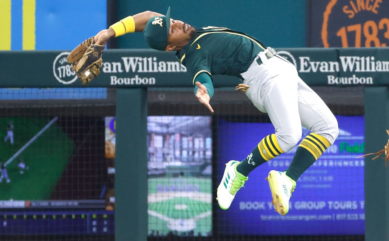 Oakland's Tony Kemp makes a leaping catch during a Major League Baseball game in Arlington, Texas, on Friday, July 9.