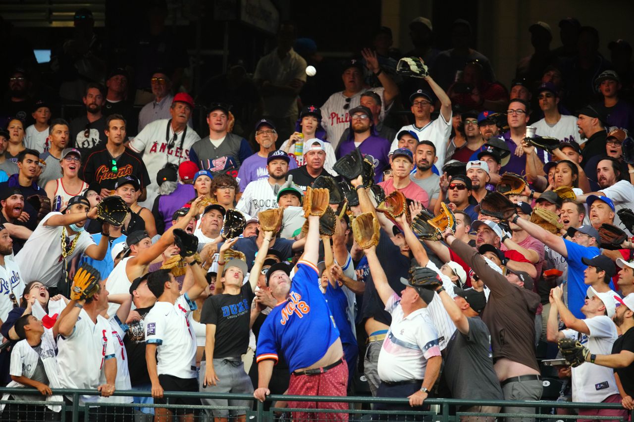 Fans reach for a ball during the MLB Home Run Derby, which took place in Denver on Monday, July 12.