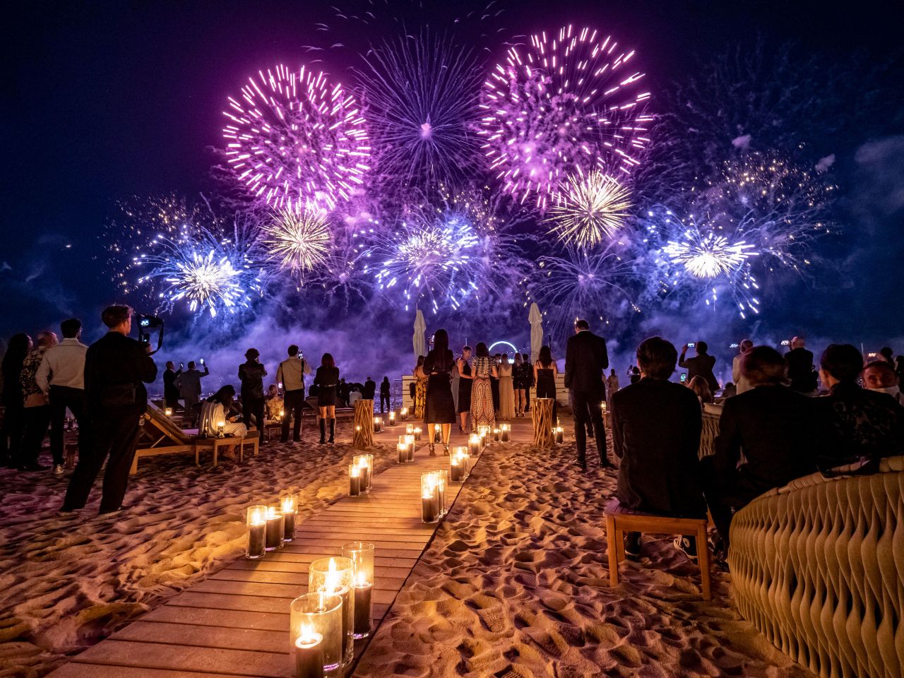 People watch Bastille Day fireworks from a beach in Cannes, France, during the Cannes Film Festival on Wednesday, July 14.
