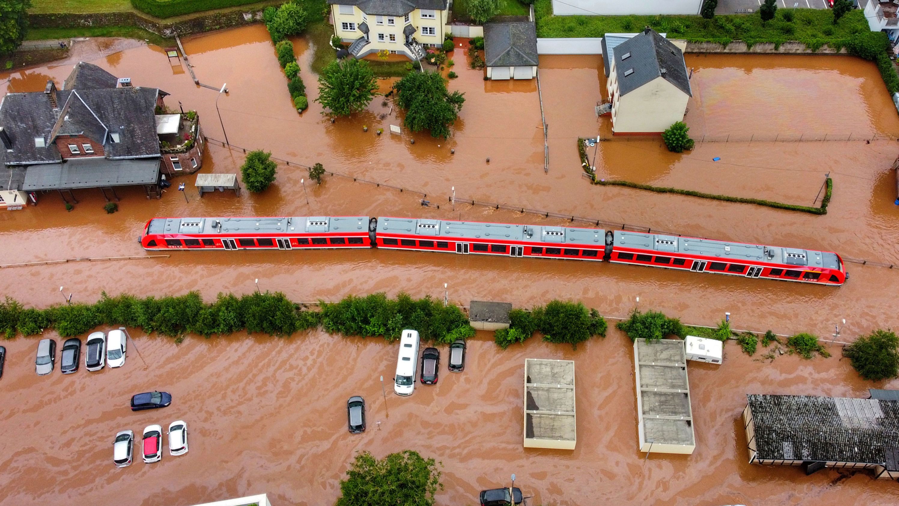 A regional train sits in floodwaters at the local station in Kordel, Germany.