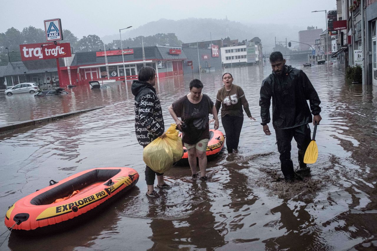 People use rafts to evacuate after the Meuse River broke its banks during heavy flooding in Liege, Belgium.