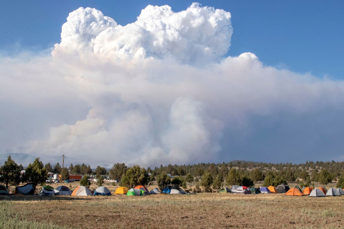 A pyrocumulus cloud caused by the Bootleg Fire drifts north of a firefighter operating base in Bly, Oregon, on July 15.