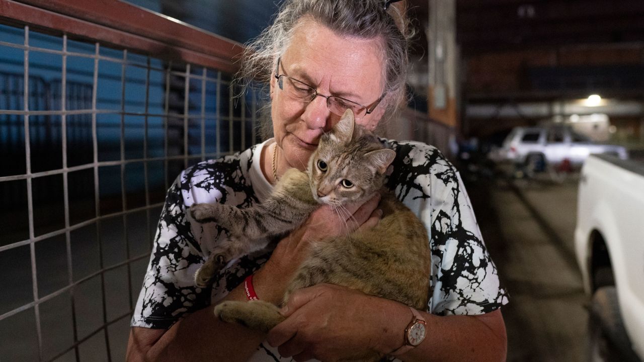 Dee McCarley hugs her cat Bunny, whom she took with her while evacuating from the Bootleg Fire on July 14, 2021.