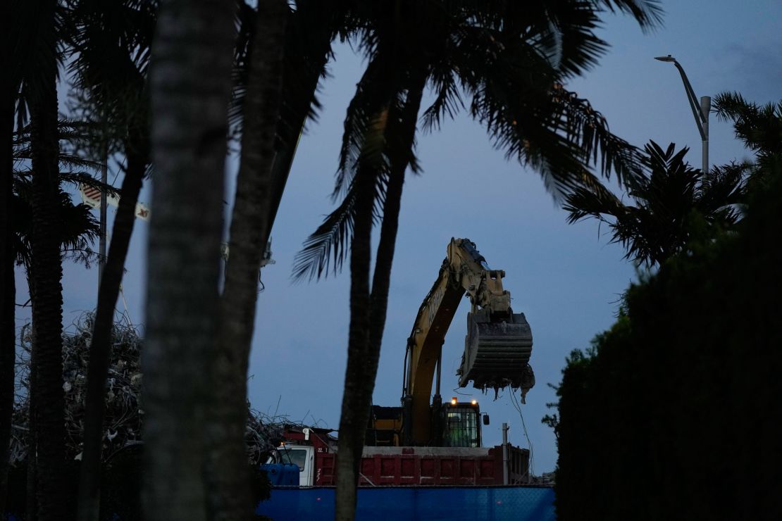 An excavator clears rubble at the site of the Champlain Towers South condo building collapse and demolition, Thursdayy.