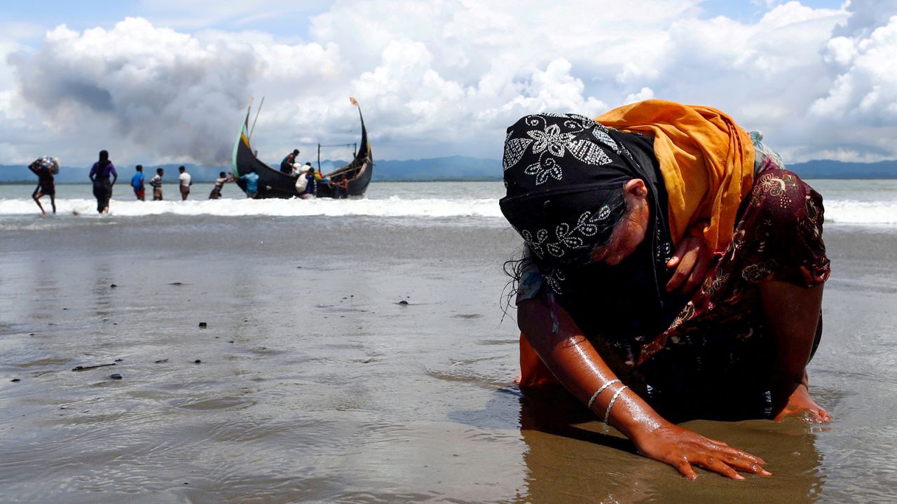 Danish Siddiqui won a Pulitzer Prize for his work on the Rohingya refugee crisis. This photo shows a Rohingya woman touching the shore after crossing the Bangladesh-Myanmar border.