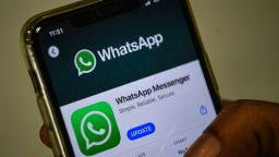 In this photo illustration taken on November 6, 2020, a user updates Facebook's WhatsApp application on his mobile phone in Mumbai. - WhatsApp on November 6 entered an increasingly tense battle between multi-national giants such as Google and AliBaba for a chunk of India's fast growing digital payments market. (Photo by Indranil MUKHERJEE / AFP) (Photo by INDRANIL MUKHERJEE/AFP via Getty Images)