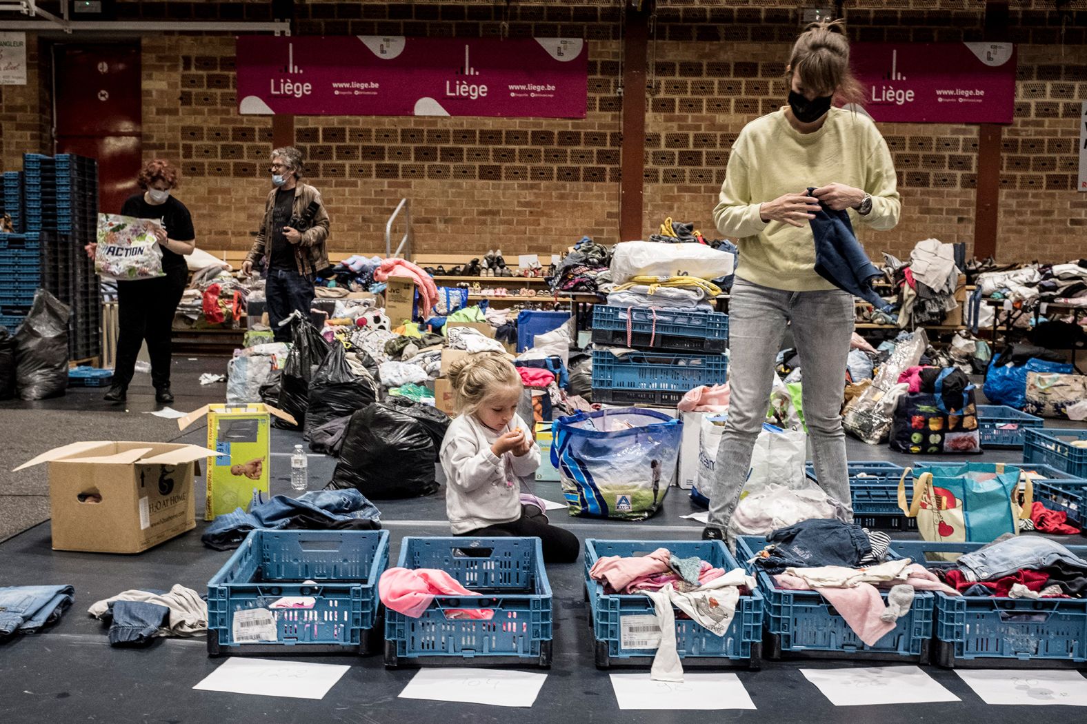 A woman sorts through clothing at a shelter in Liege, Belgium, on Friday.