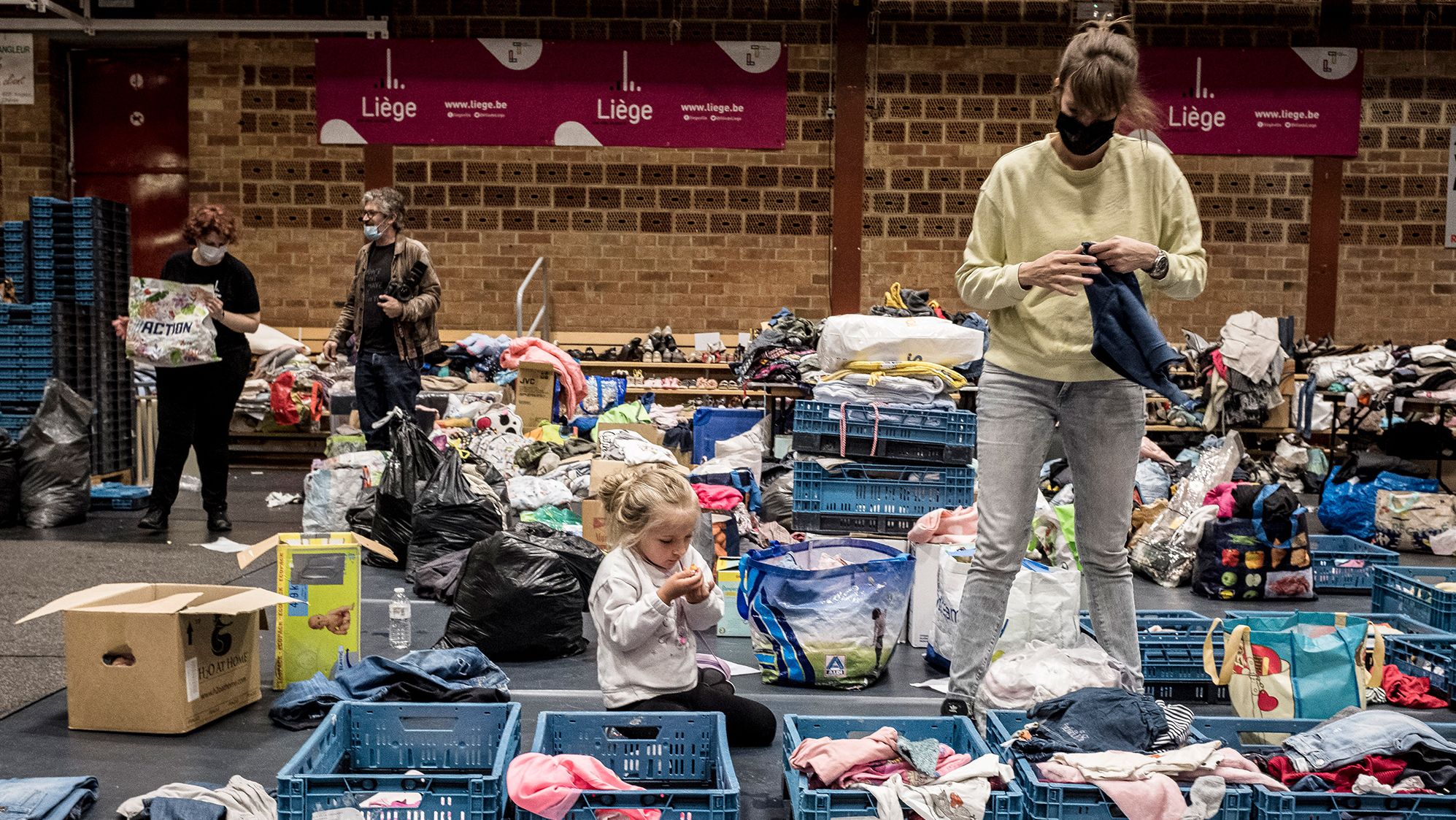 A woman sorts through clothing at a shelter in Liege, Belgium, on Friday.