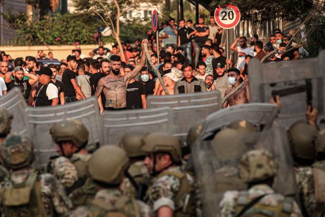 Protesters confront Lebanese soldiers during a demonstration after Prime Minister-designate Saad Hariri stepped down following his failure to form a government.