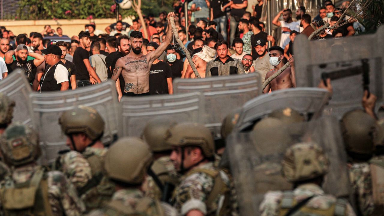 Protesters confront Lebanese soldiers during a demonstration after Prime Minister-designate Saad Hariri stepped down following his failure to form a government.