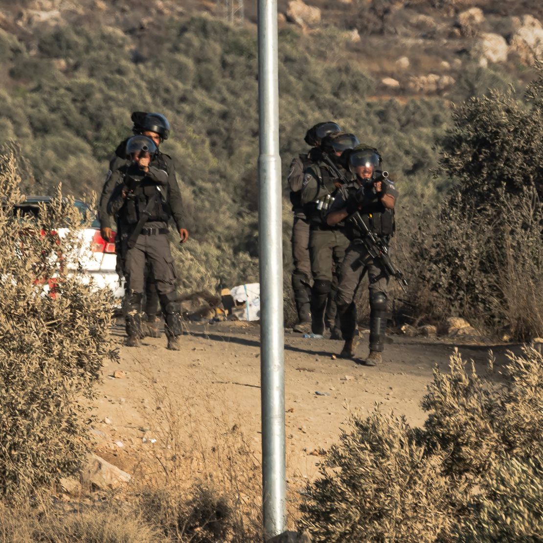 Israeli soldiers ready to fire tear gas canisters in Beita.