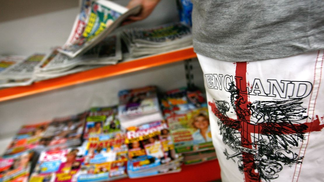 A British holidaymaker picks up a UK newspaper a store Lloret de Mar, Spain.