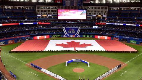 Members of the Toronto Blue Jays and the Detroit Tigers lineup before an opening day baseball game at Rogers Centre in Toronto in this Thursday, March 28, 2019, file photo.