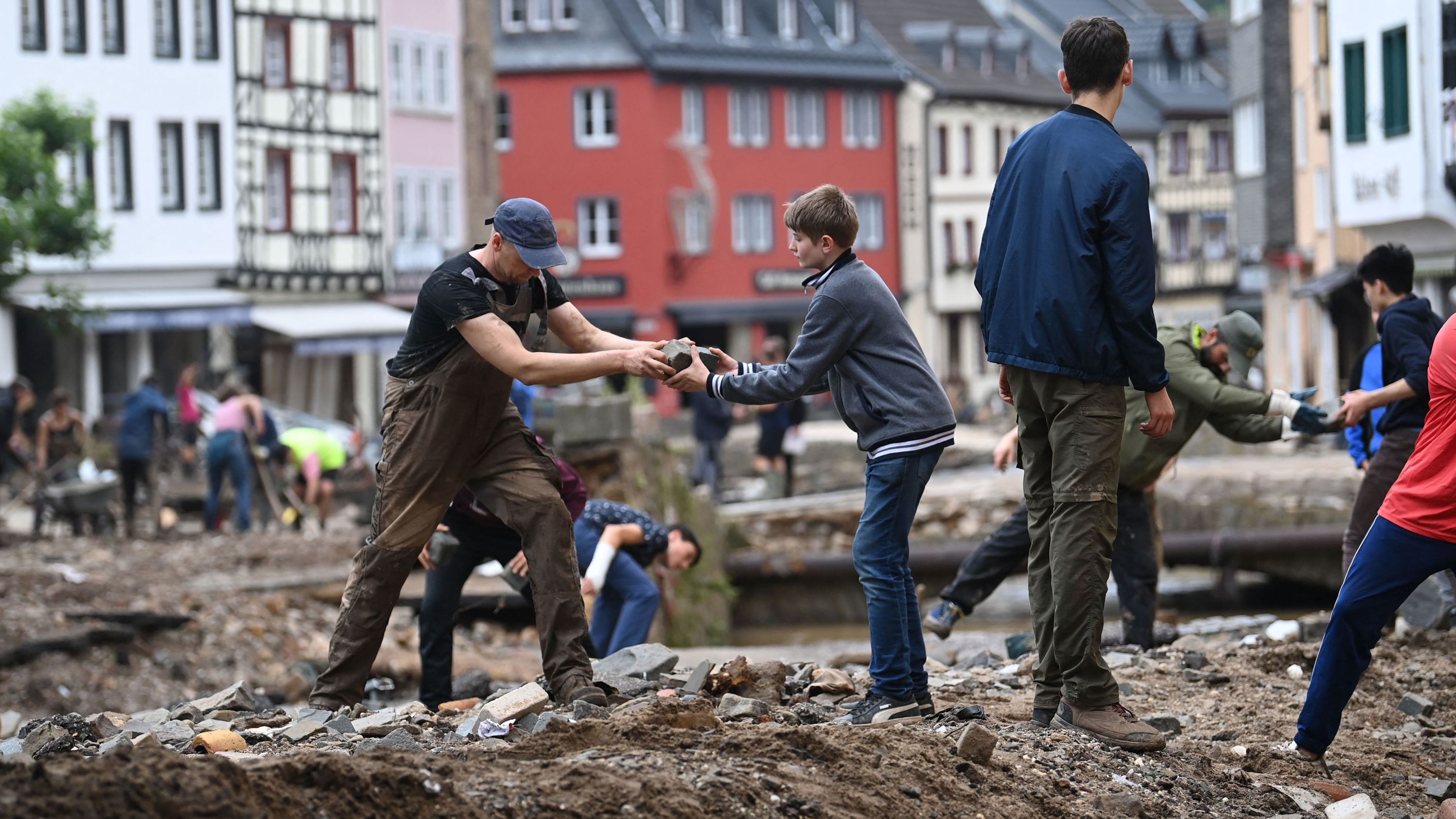 People collect debris in Bad Muenstereifel, Germany.