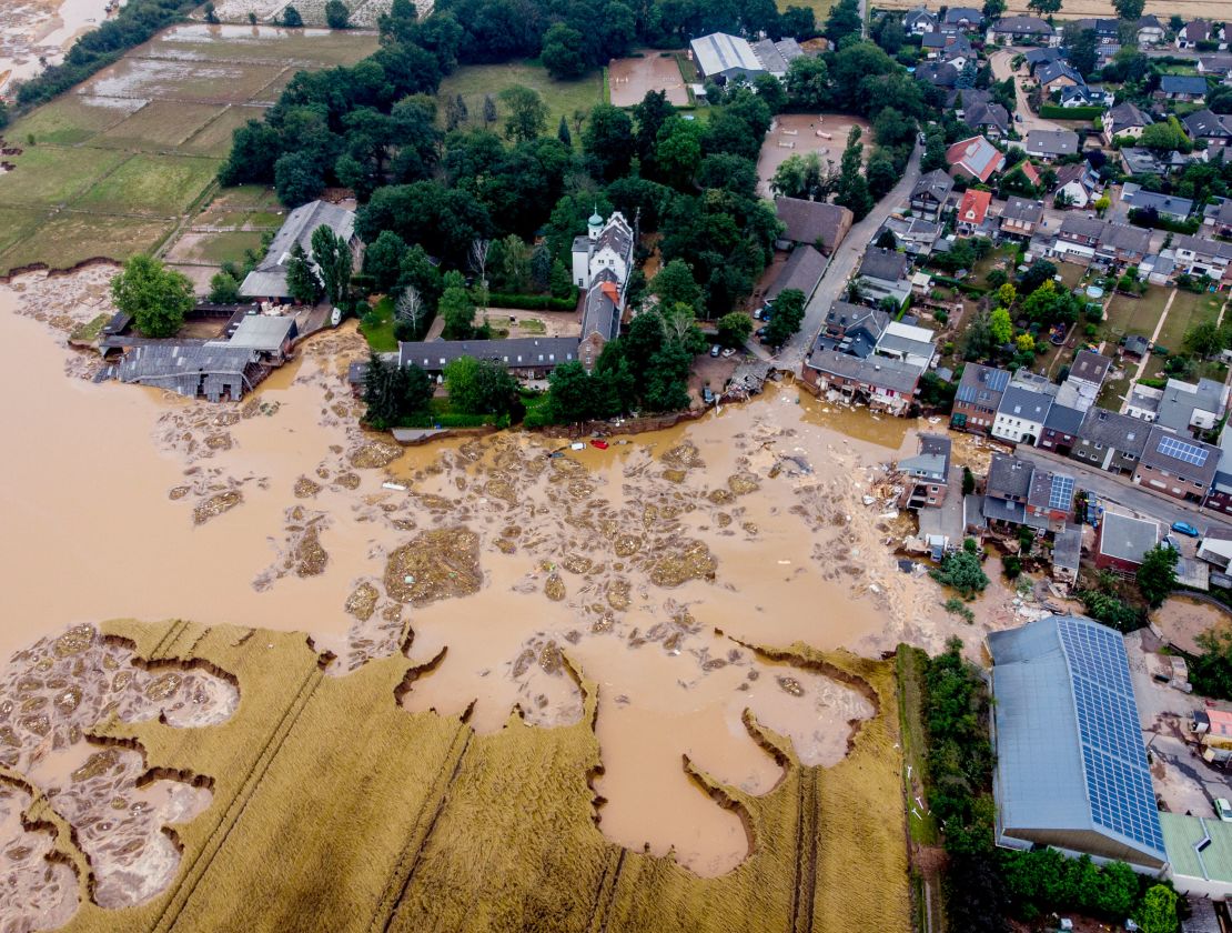 A damaged castle, left, is seen in Erftstadt-Blessem, Germany, Saturday, July 17, 2021. 