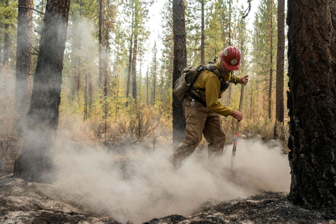 Firefighter Garrett Suza, with the Chiloquin Forest Service, mops up a hot spot on the northeast side of the Bootleg Fire, Wednesday, July 14, 2021, near Sprague River, Oregon.