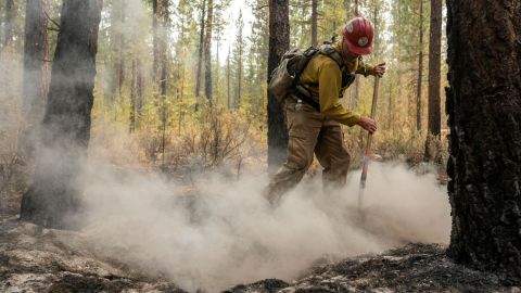 Firefighter Garrett Suza, with the Chiloquin Forest Service, mops up a hot spot on the northeast side of the Bootleg Fire, Wednesday, July 14, 2021, near Sprague River, Oregon. 