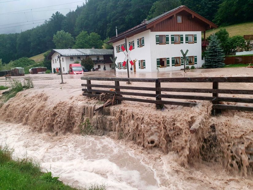 Water flows over a square in front of a house in Bischofswiesen, Germany.