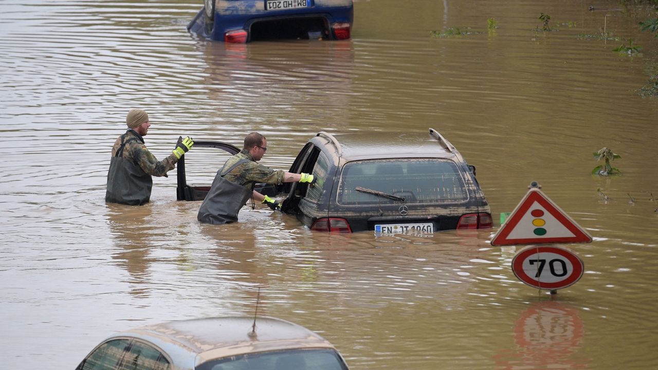 German soldiers search for flood victims in submerged vehicles on the federal highway B265 in Erftstadt, western Germany, on July 17, 2021, after heavy rains hit parts of the country, causing widespread flooding and major damage.