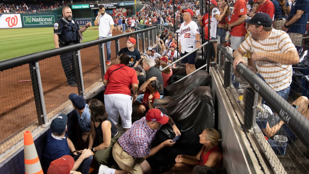 Fans take cover after gunshots were heard during the game between the Washington Nationals and the San Diego Padres at Nationals Park.