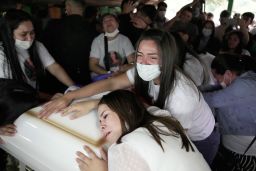 Relatives of Leidy Vanessa Luna Villalba mourn over her coffin during a wake at her home in Eugenio Garay, Paraguay, Tuesday, July 13, 2021. 