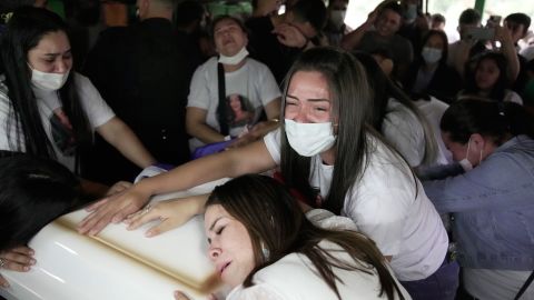 Relatives of Leidy Vanessa Luna Villalba mourn over her coffin during a wake at her home in Eugenio Garay, Paraguay, Tuesday, July 13, 2021.