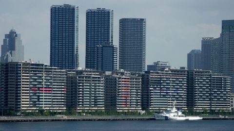 National banners hang from balconies at an athlete's village as Tokyo prepares for the 2020 Summer Olympics, Saturday, July 17, 2021.