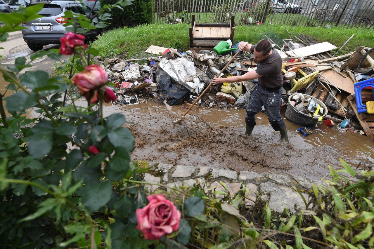 A resident stands in floodwaters in Rochefort, Belgium, on Saturday.