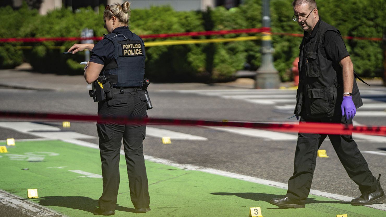 Police investigate an overnight shooting Saturday, July 17, 2021 in Portland, Oregon.