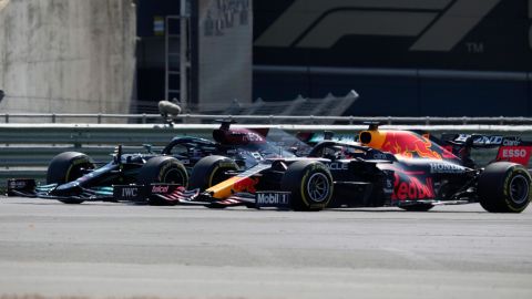 Hamilton and Max Verstappen take a curve side-by-side at the start of the British Grand Prix.