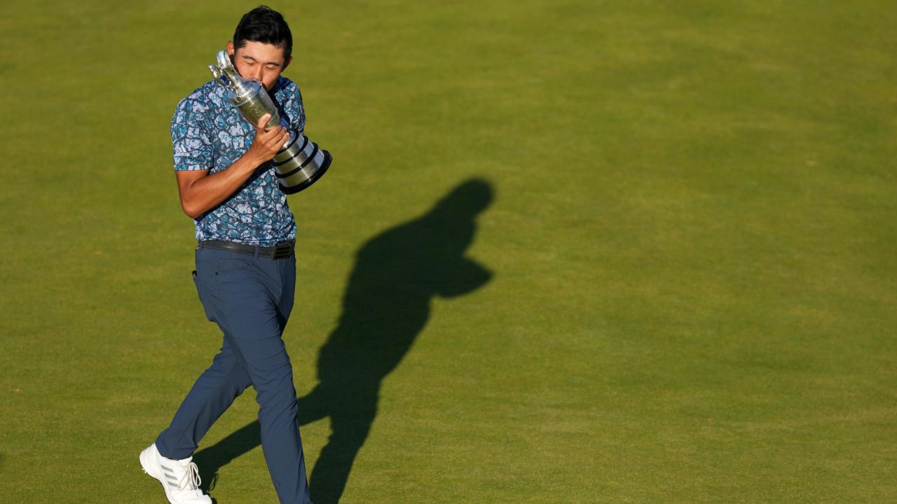 Morikawa celebrates with the Claret Jug on the 18th green after winning the Open.