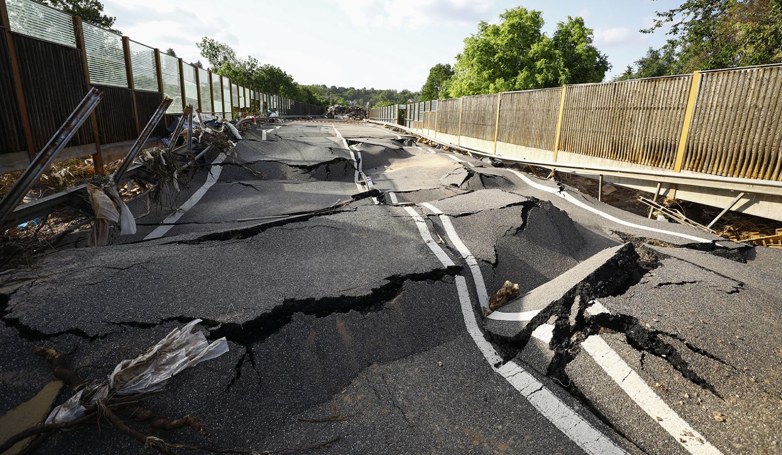 A damaged road buckles after flooding in Euskirchen, Germany.