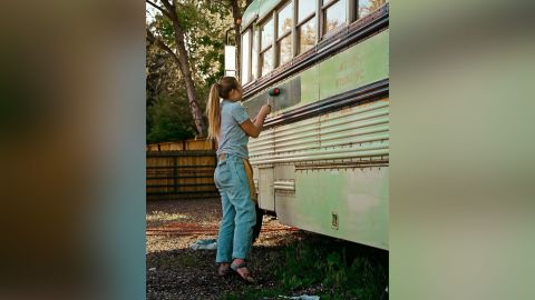 Abi Roberts painting the bus before the trip.