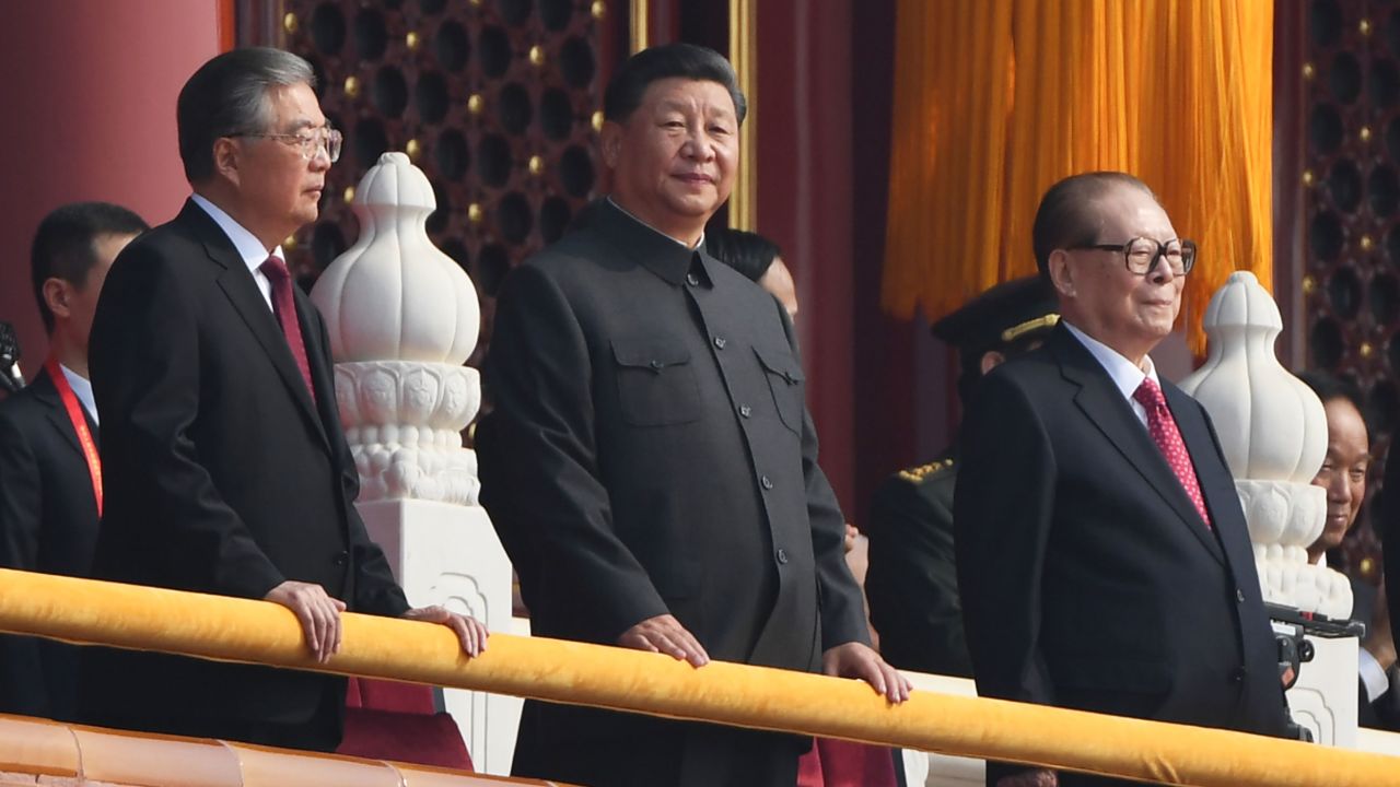 Chinese President Xi Jinping, center, attends a military parade with former presidents Hu Jintao, left, and Jiang Zemin in Tiananmen Square in Beijing on October 1, 2019.