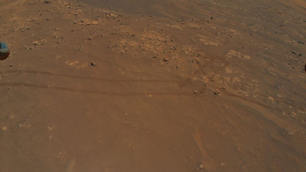 The Ingenuity helicopter is flying in parallel with the Perseverance rover as it drives on Mars -- as shown by the rover tracks captured by the chopper's camera on July 5.