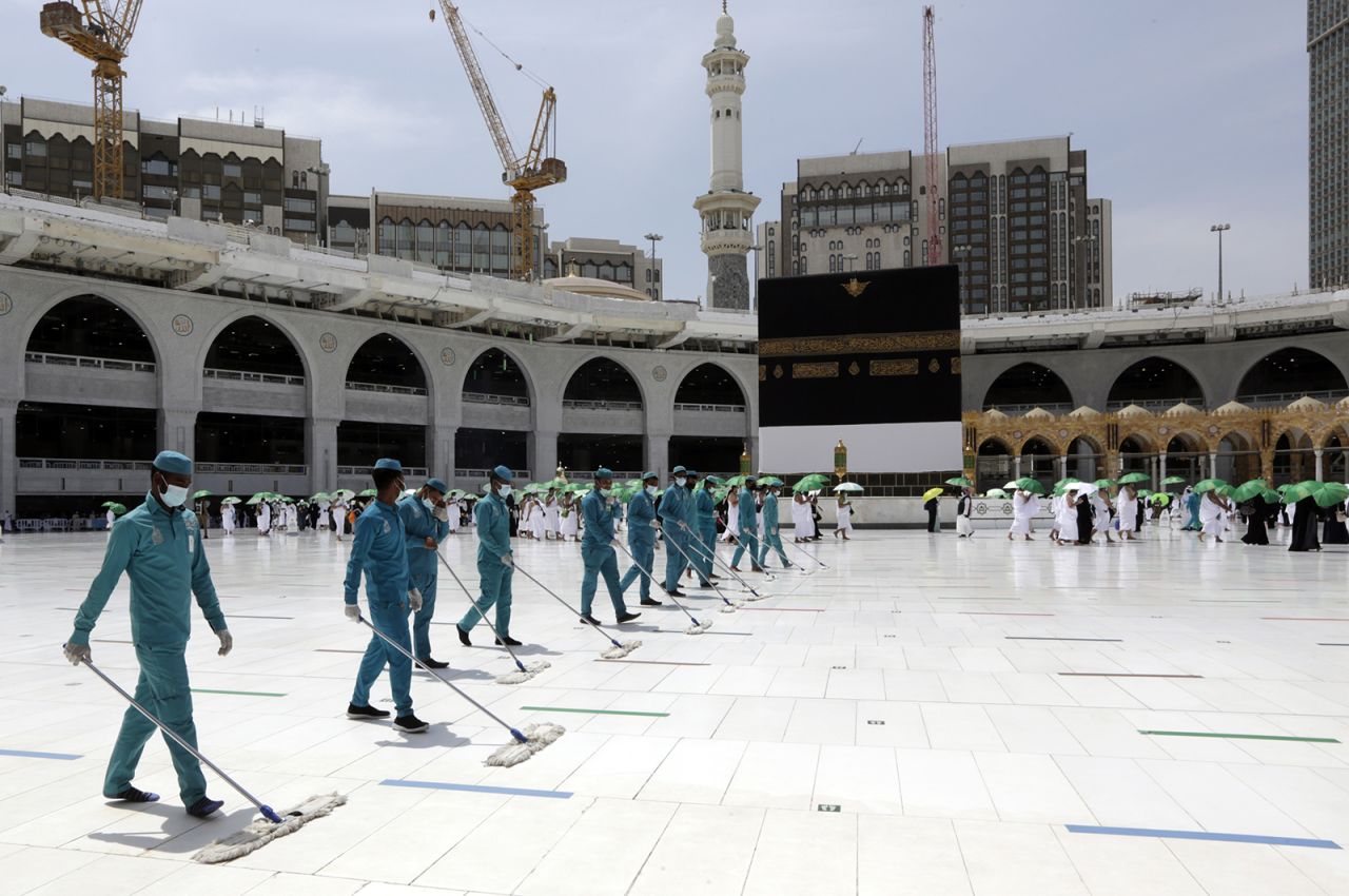 Workers at the Grand Mosque disinfect the grounds around the Kaaba on Saturday.