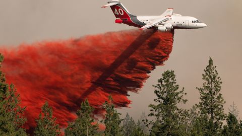 An airplane drops fire retardant on the Chuweah Creek Fire in Washington on July 14.