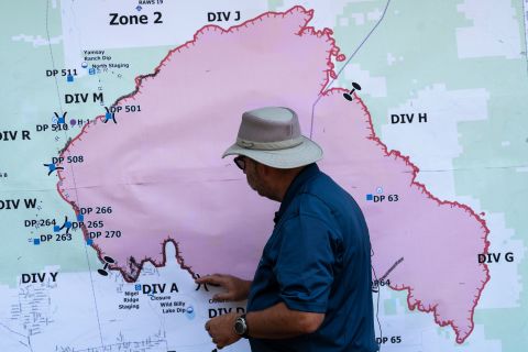 Operations Section Chief Bert Thayer examines a map of the Bootleg Fire in Chiloquin, Oregon, on July 13.