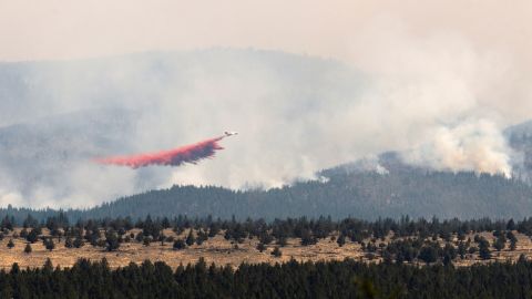 A firefighting aircraft drops flame-retarding chemicals on the Bootleg Fire in Bly, Oregon, on July 15.
