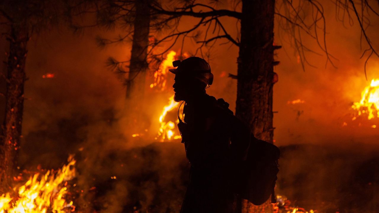 A firefighter battles the Bootleg Fire in the Fremont-Winema National Forest, along the Oregon and California border, on July 15.