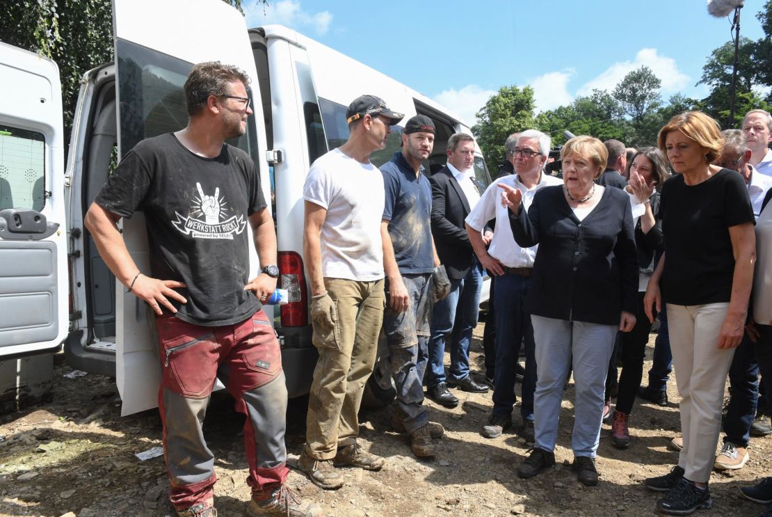 German Chancellor Angela Merkel, second right, and Rhineland-Palatinate State Premier Malu Dreyer, right, talk to residents during their visit to Schuld on July 18 after the flood hit.