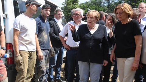 German Chancellor Angela Merkel, second right, and Rhineland-Palatinate State Premier Malu Dreyer, right, talk to residents during their visit to Schuld on July 18 after the flood hit.