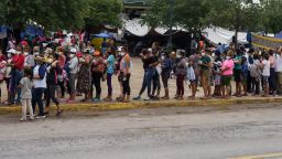 Migrants who were sent back to Mexico under Title 42 wait in line for food and supplies in a camp across the US-Mexico border in Reynosa, Tamaulipas, Mexico on July 10, 2021. - There are about 1,000 people from Central America and other Latin American countries living in the camp, hoping for a chance to enter the United States. Republican lawmakers have slammed Biden for reversing Trump programs, including his "remain in Mexico" policy, which had forced thousands of asylum seekers from Central America to stay south of the US border until their claims were processed. (Photo by PAUL RATJE / AFP) (Photo by PAUL RATJE/AFP via Getty Images)