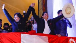 Peru's Pedro Castillo waves to supporters with his running mate Dina Boluarte during a celebration after being confirmed as President-elect on July 9.
